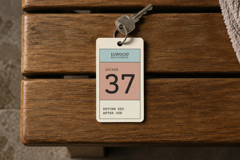 Locker key tag numbered 37 resting on a timber bench