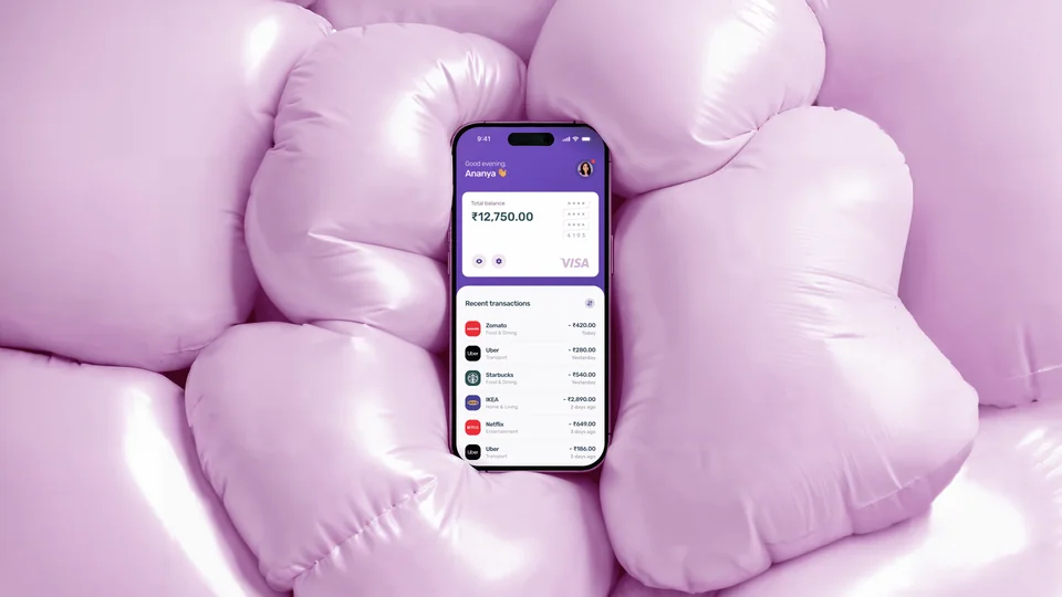 Phone showing the Slice app resting on soft pink inflatable shapes