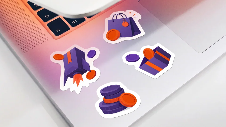 Slice stickers of a shopping bag, gift and coins on a laptop