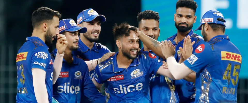 Mumbai Indians cricketers celebrating in jerseys with the slice logo